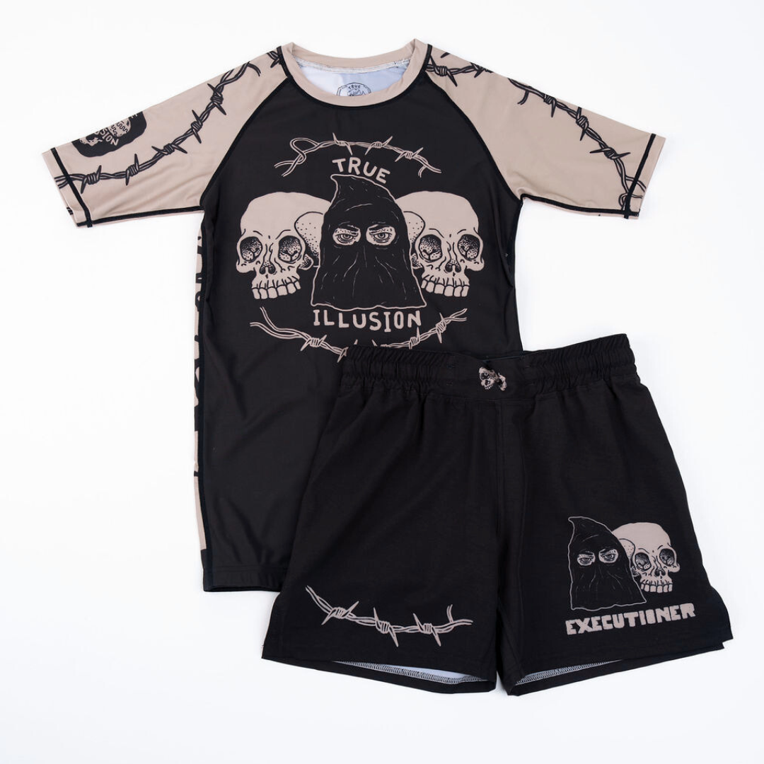 Black and beige shirt with skull design and black shorts on a white background