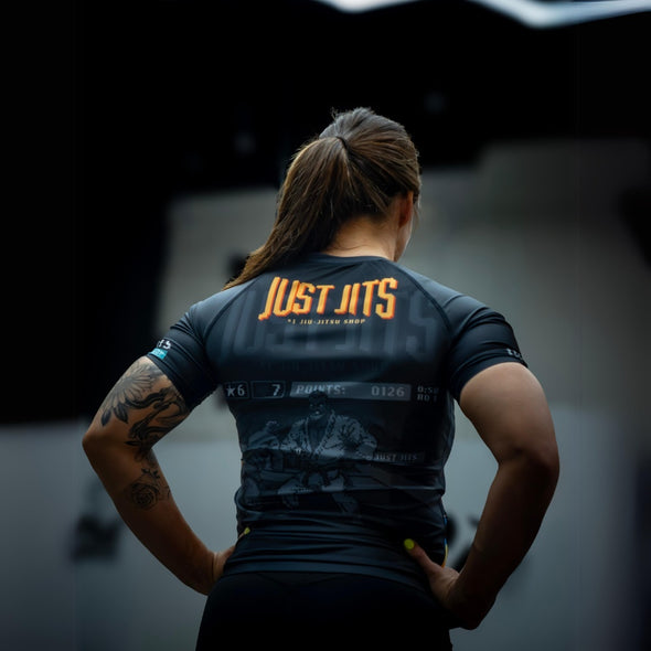 Elevate your No Gi game with the Just Jits Short Sleeve Rashguard - 8 Bit! Engineered for durability and performance in Brazilian Jiu Jitsu.