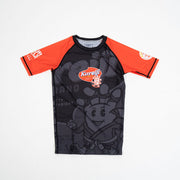 Black and orange shirt with cartoon character and brand logo on a white background