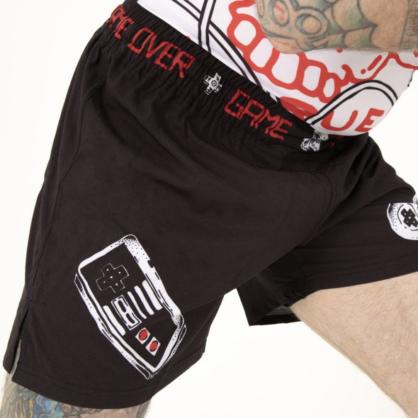 Side Profile of Model wearing Game Over Combat Shorts by True Illusion: MMA Grappling Shorts, designed for BJJ practitioners and MMA fighters