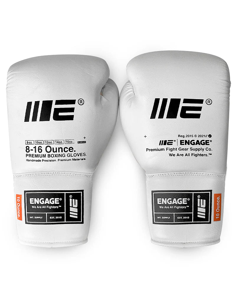 Pair of white boxing gloves with black branding on a white background
