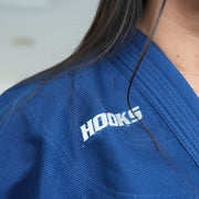 Hooks BJJ Gi Prolight II Navy, close-up of chest logo and lapel worn by a person