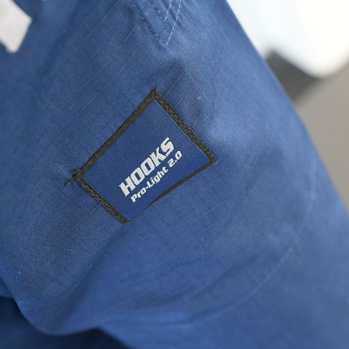 Hooks BJJ Gi Prolight II Navy, close-up of woven patch label on sleeve