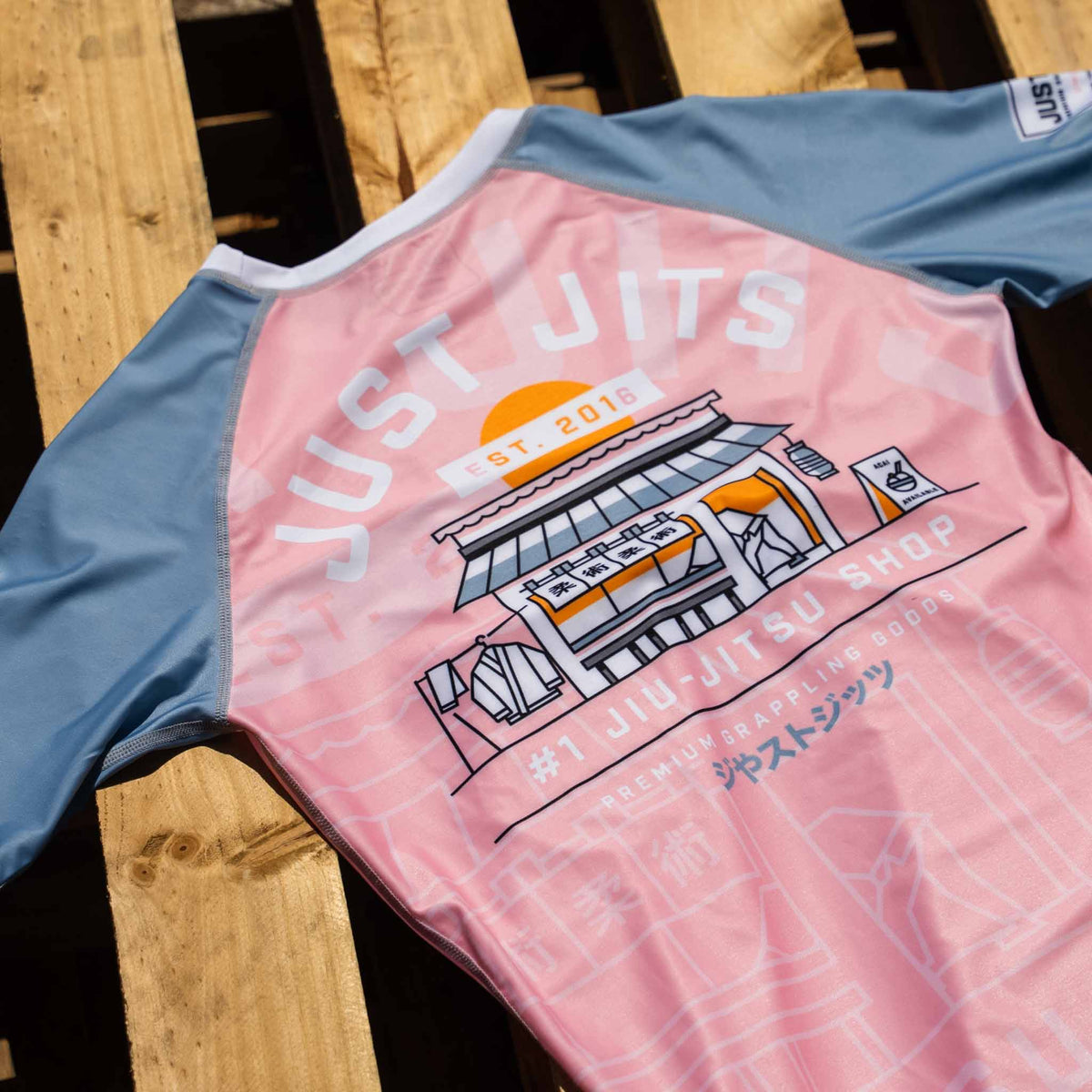 Just Jits Women's Short Sleeve Rash Guard – Sunset Sakura flat lay