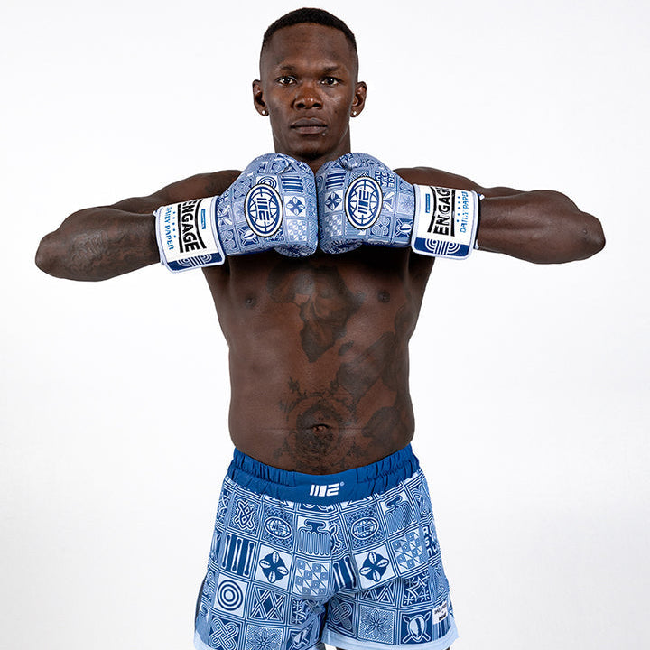 Israel Adesanya in Blue boxing shorts and boxing gloves