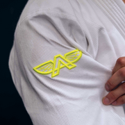 Close-up of the embroidered logo on The Atlas Brand ICON White rashguard