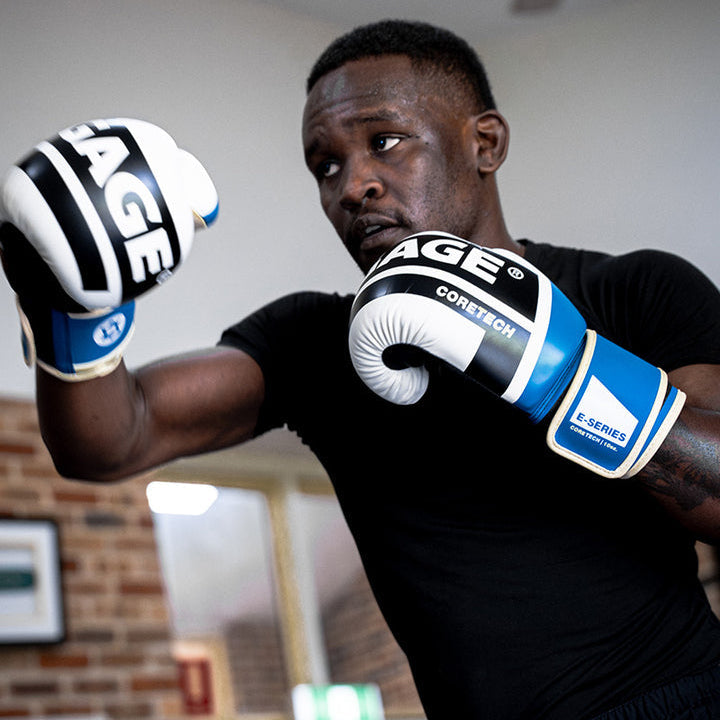 Israel Adesanya wearing boxing gloves
